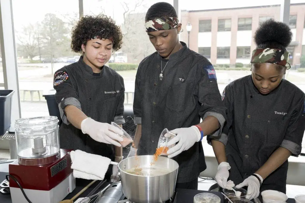 The Phoebus High School culinary team working together to prepare their dish for the judges at the HUNCH Culinary Challenge at NASA's Langley Research Center.
Credits: NASA / Mark Knopp